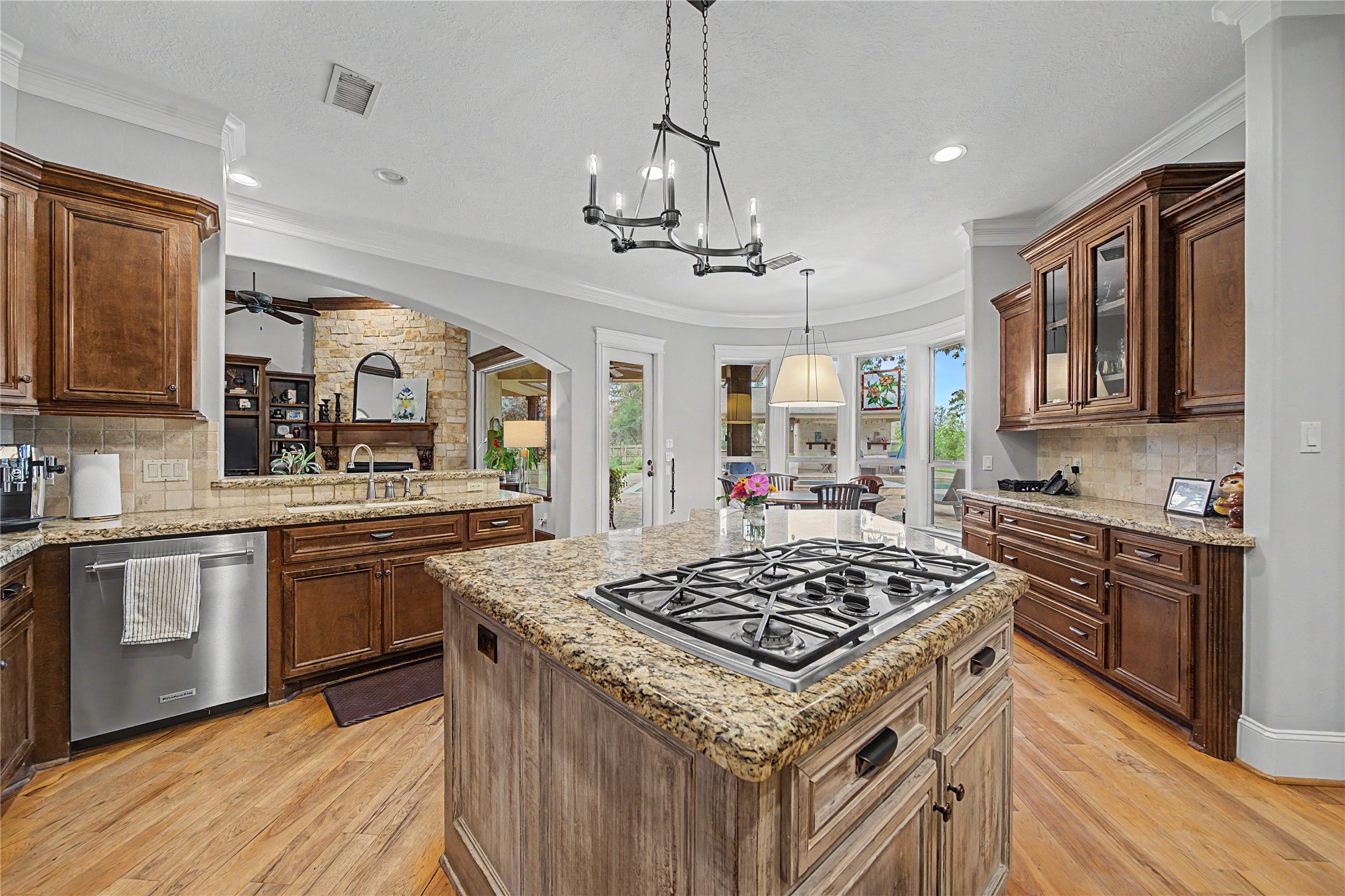 4423 Silver Jade Drive Spring, TX 77386 - Photo 10 of 45 a kitchen with stainless steel appliances granite countertop a stove a sink dishwasher a refrigerator and a dining table with wooden floor