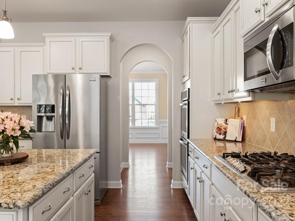 1335 Bryson Gap Drive Fort Mill, SC 29715 - Photo 13 of 29 a kitchen with stainless steel appliances granite countertop a stove a sink and a refrigerator