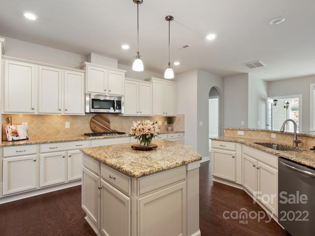 1335 Bryson Gap Drive Fort Mill, SC 29715 - Photo 14 of 29 a kitchen with kitchen island granite countertop a sink a stove and cabinets