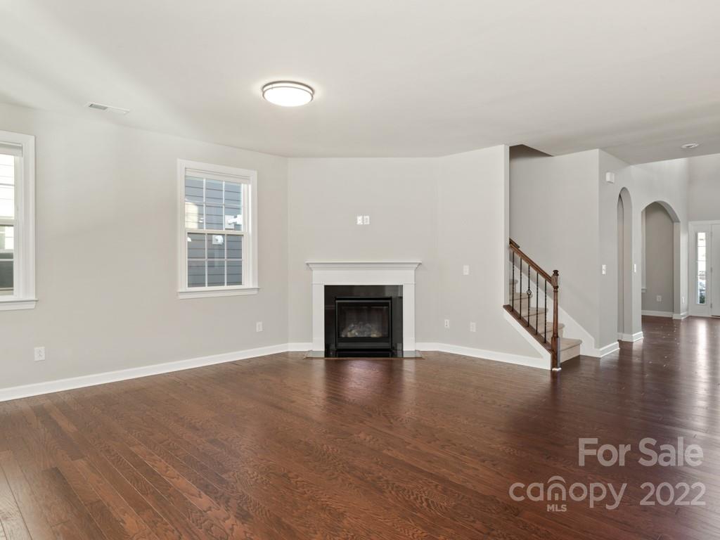 1335 Bryson Gap Drive Fort Mill, SC 29715 - Photo 7 of 29 a view of an empty room with window and wooden floor