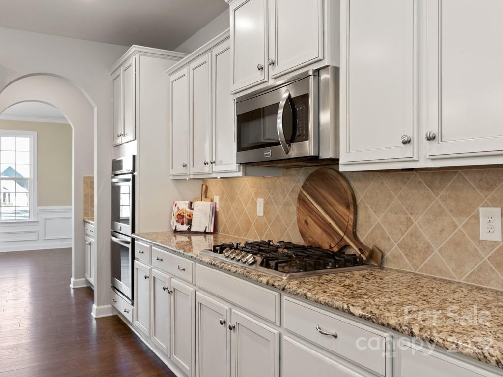 1335 Bryson Gap Drive Fort Mill, SC 29715 - Photo 10 of 29 a kitchen with stainless steel appliances granite countertop a stove a sink and a white cabinets