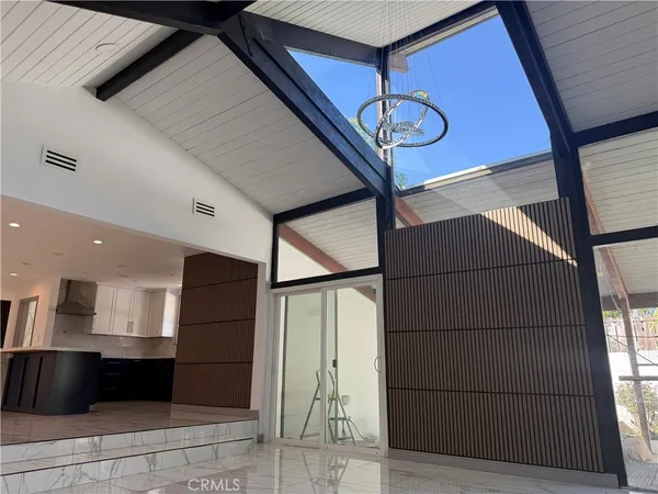 a kitchen with stainless steel appliances kitchen island granite countertop a refrigerator a stove and a sink