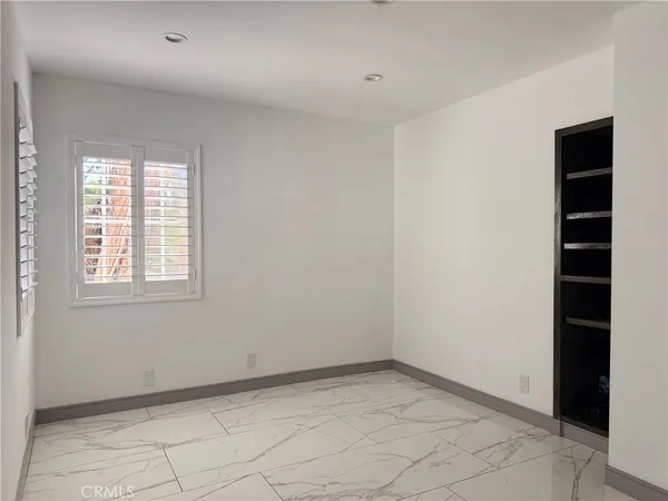 a bathroom with a sink shower and a mirror