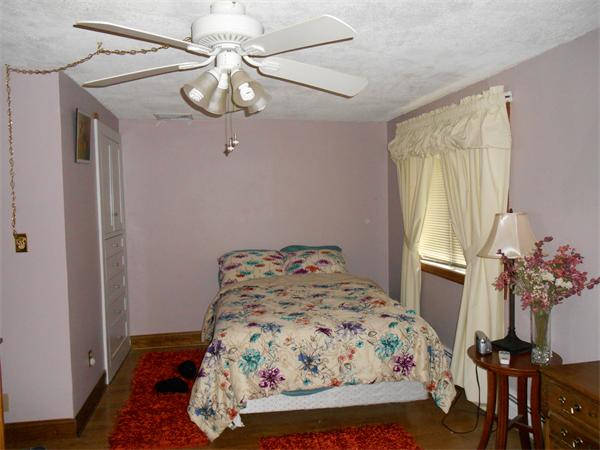 106 Lexington Road Billerica, MA 01821 - Photo 13 of 14 a bedroom with a bed and a chandelier