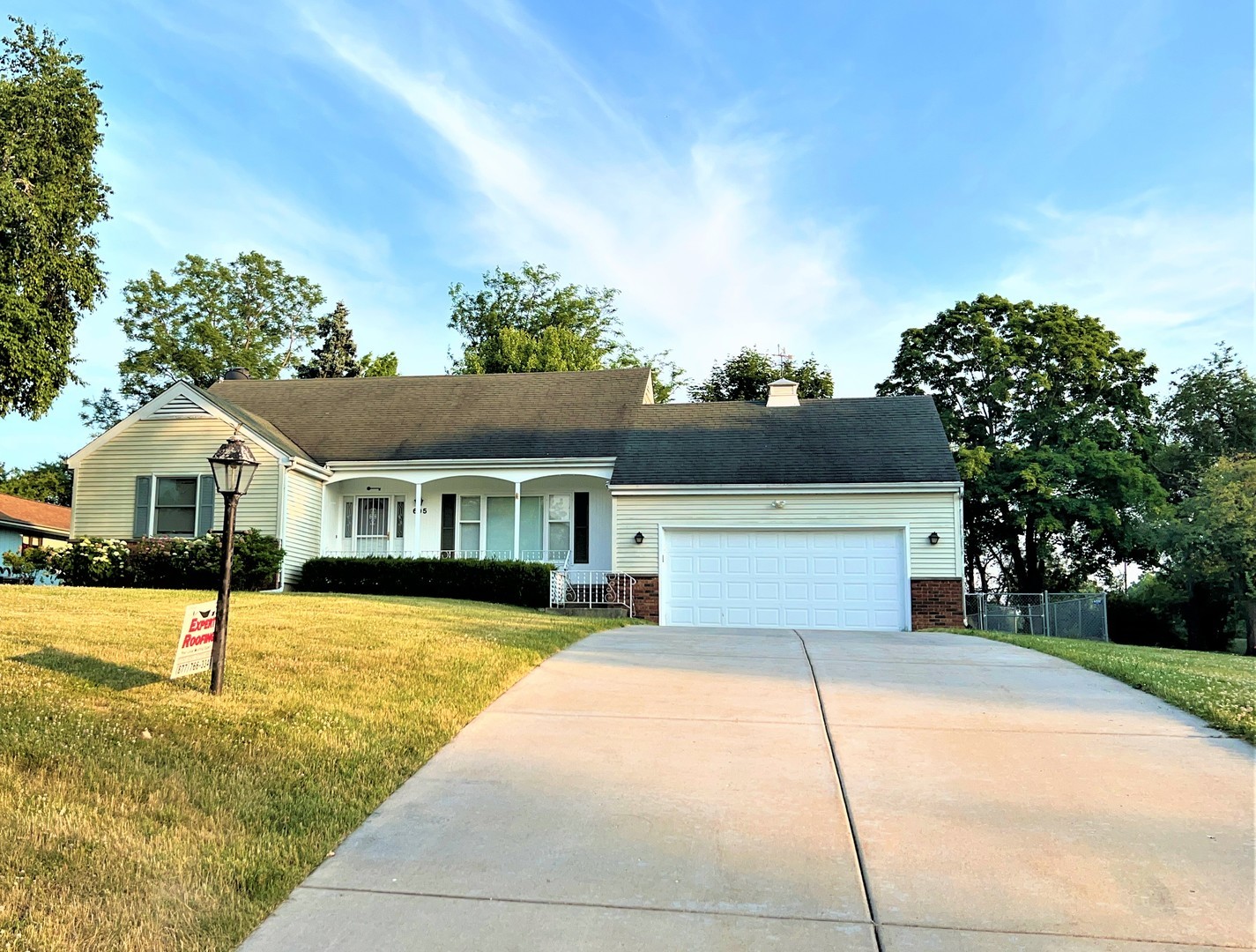 605 Old Orchard Road Harvard, IL 60033 - Photo 2 of 3 a front view of a house with a yard and garage