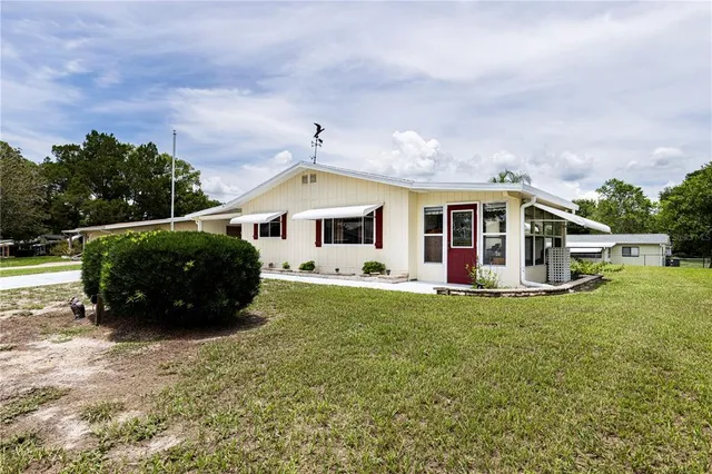 a view of house with backyard and porch