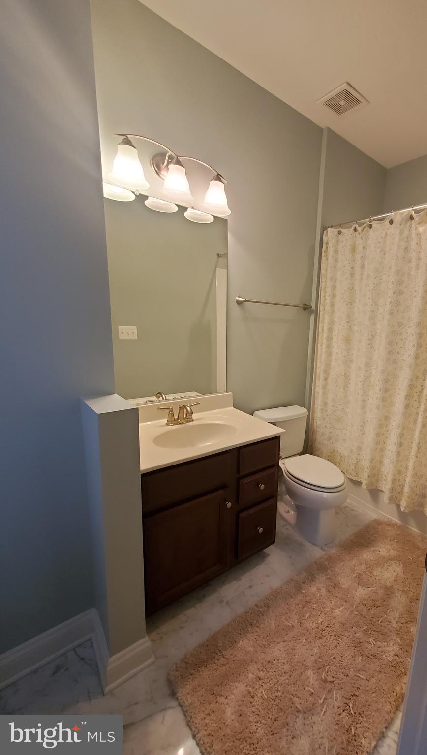 503 Rampart Way, Unit 16 Oxon Hill, MD 20745 - Photo 14 of 35 a bathroom with a sink vanity mirror and toilet