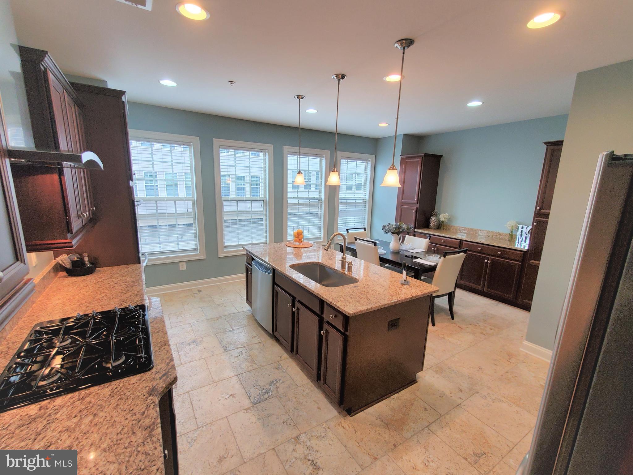 503 Rampart Way, Unit 16 Oxon Hill, MD 20745 - Photo 5 of 35 a large kitchen with kitchen island a large counter top space appliances and cabinets