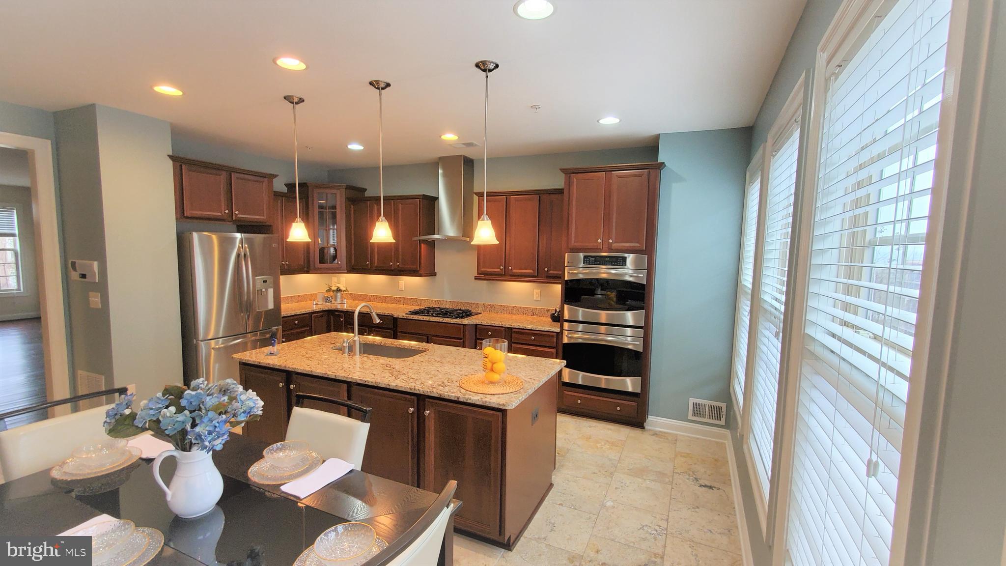 503 Rampart Way, Unit 16 Oxon Hill, MD 20745 - Photo 6 of 35 a large kitchen with a table and chairs