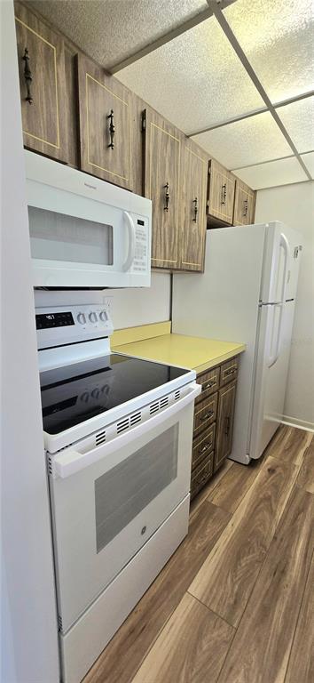 12200 Vonn Road, Unit 1305 Largo, FL 33774 - Photo 15 of 22 a kitchen with stainless steel appliances a stove and white cabinets