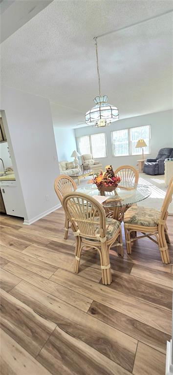 12200 Vonn Road, Unit 1305 Largo, FL 33774 - Photo 10 of 22 a view of a dining room with furniture and chandelier