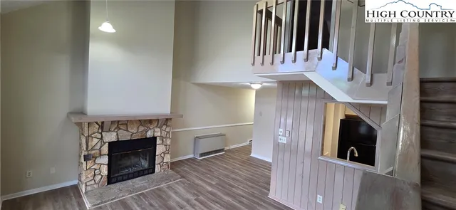 a view of a livingroom with furniture and a fireplace