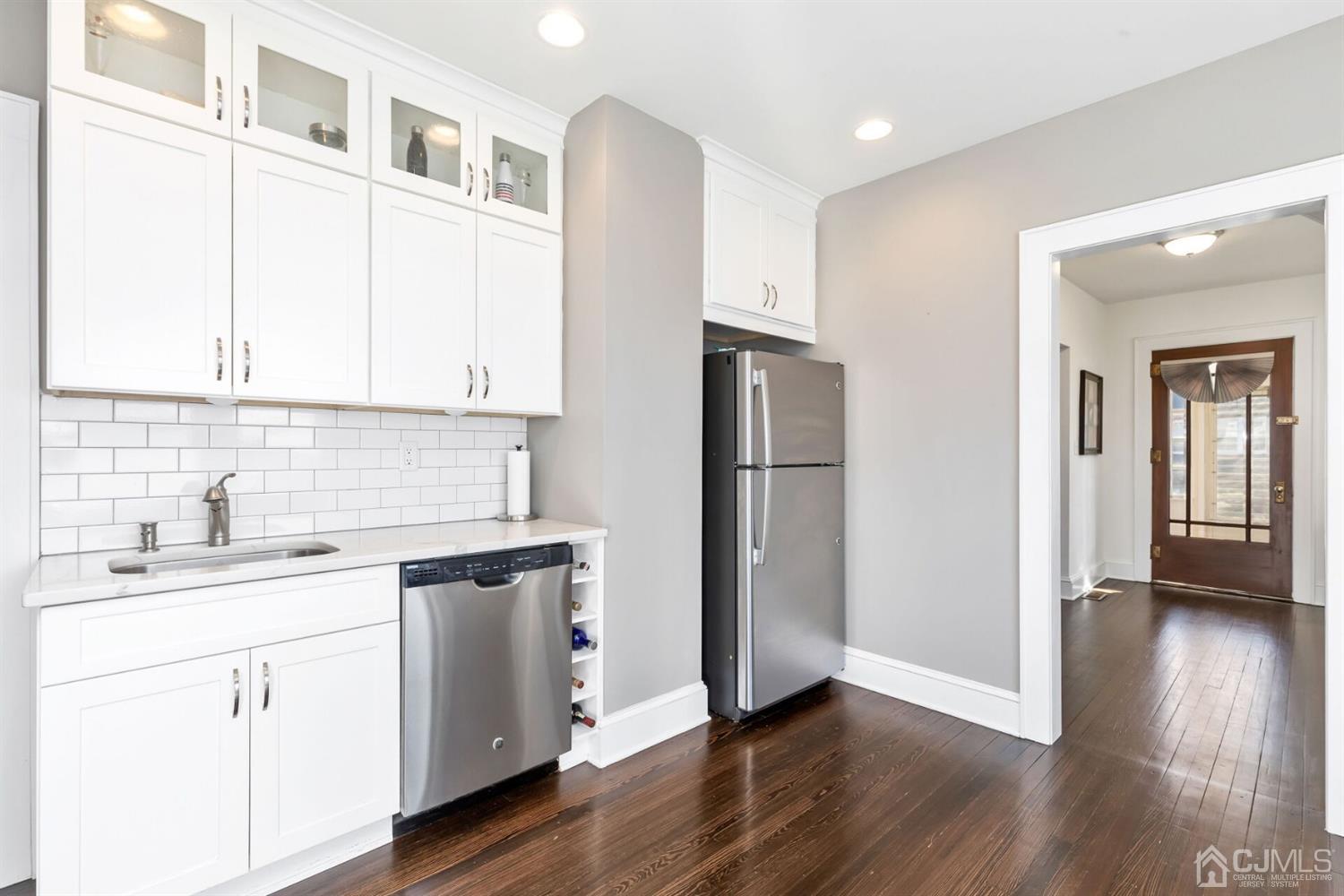 323 Washington Road Sayreville, NJ 08872 - Photo 18 of 40 a kitchen with a sink cabinets stainless steel appliances and wooden floor