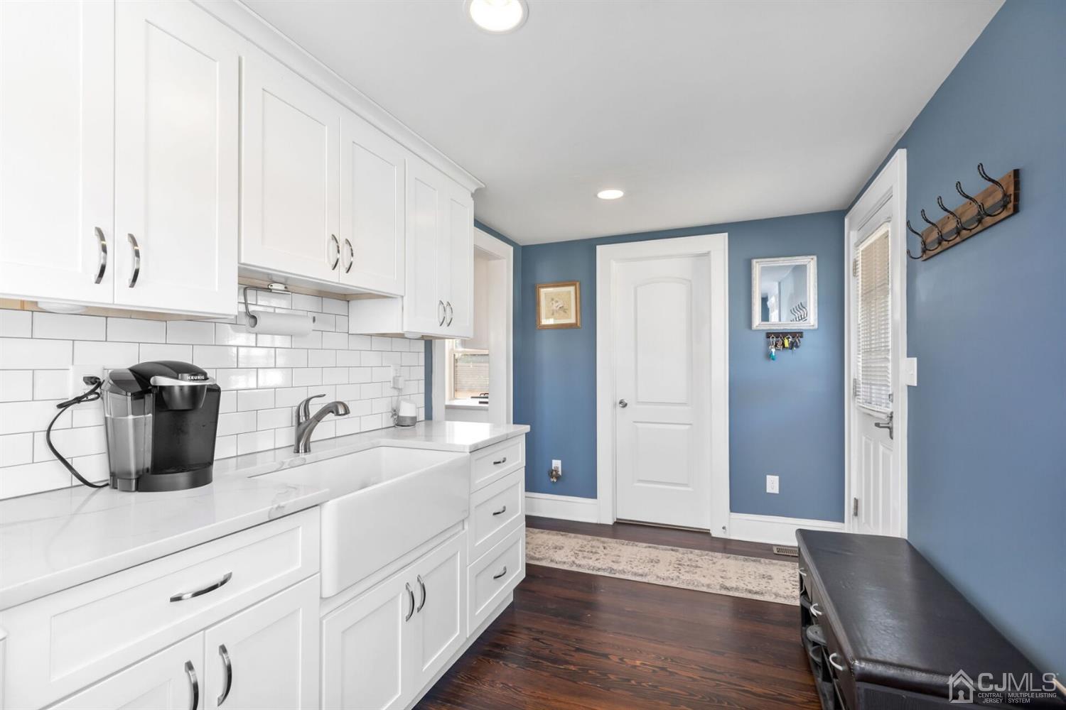 323 Washington Road Sayreville, NJ 08872 - Photo 20 of 40 a kitchen with white cabinets and sink