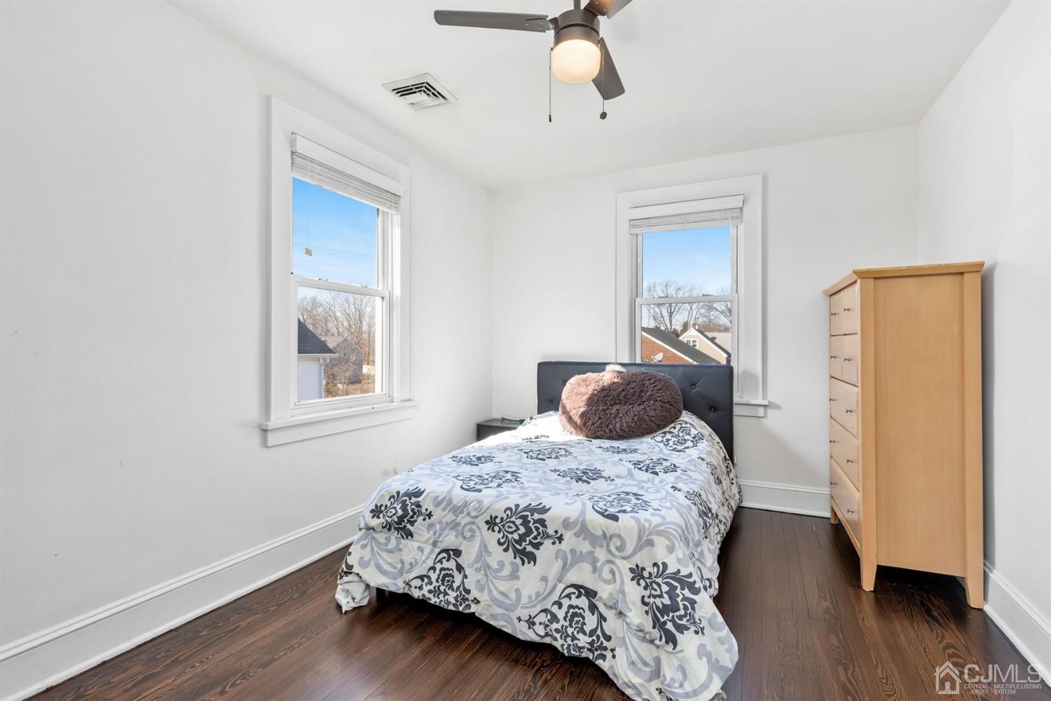 323 Washington Road Sayreville, NJ 08872 - Photo 22 of 40 a bedroom with a bed and wooden floor