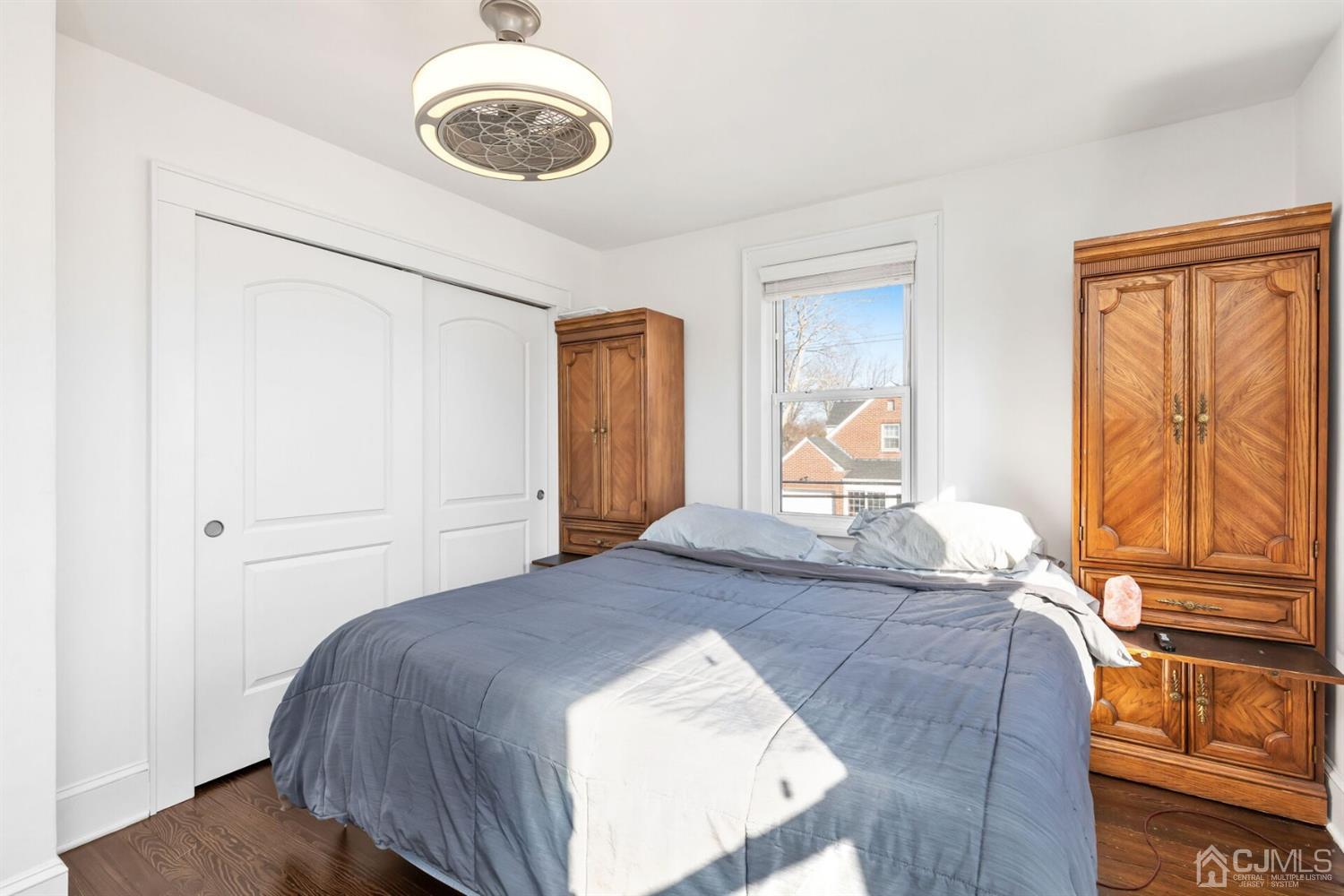 323 Washington Road Sayreville, NJ 08872 - Photo 25 of 40 a bedroom with a bed and dresser with wooden floor