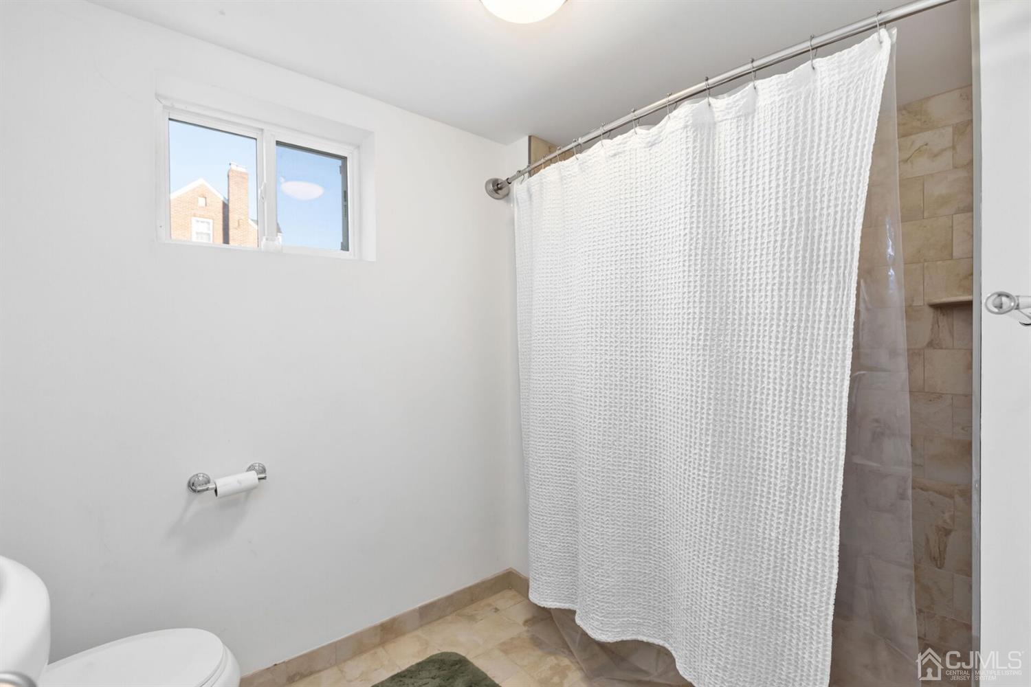 323 Washington Road Sayreville, NJ 08872 - Photo 30 of 40 a bathroom with a sink and a mirror