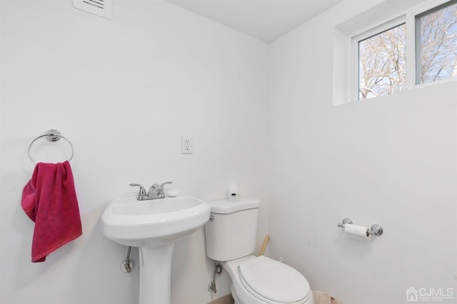 323 Washington Road Sayreville, NJ 08872 - Photo 31 of 40 a bathroom with a sink and mirror
