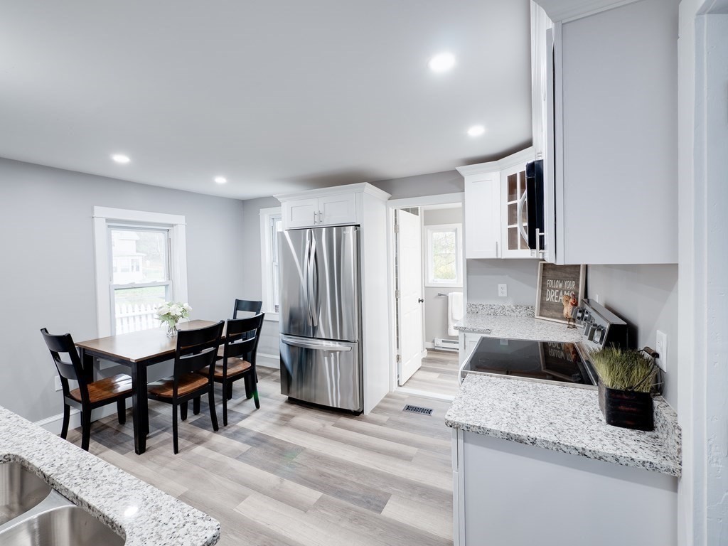 1104 Huntington Road Russell, MA 01071 - Photo 7 of 30 a kitchen with stainless steel appliances granite countertop sink refrigerator and cabinets