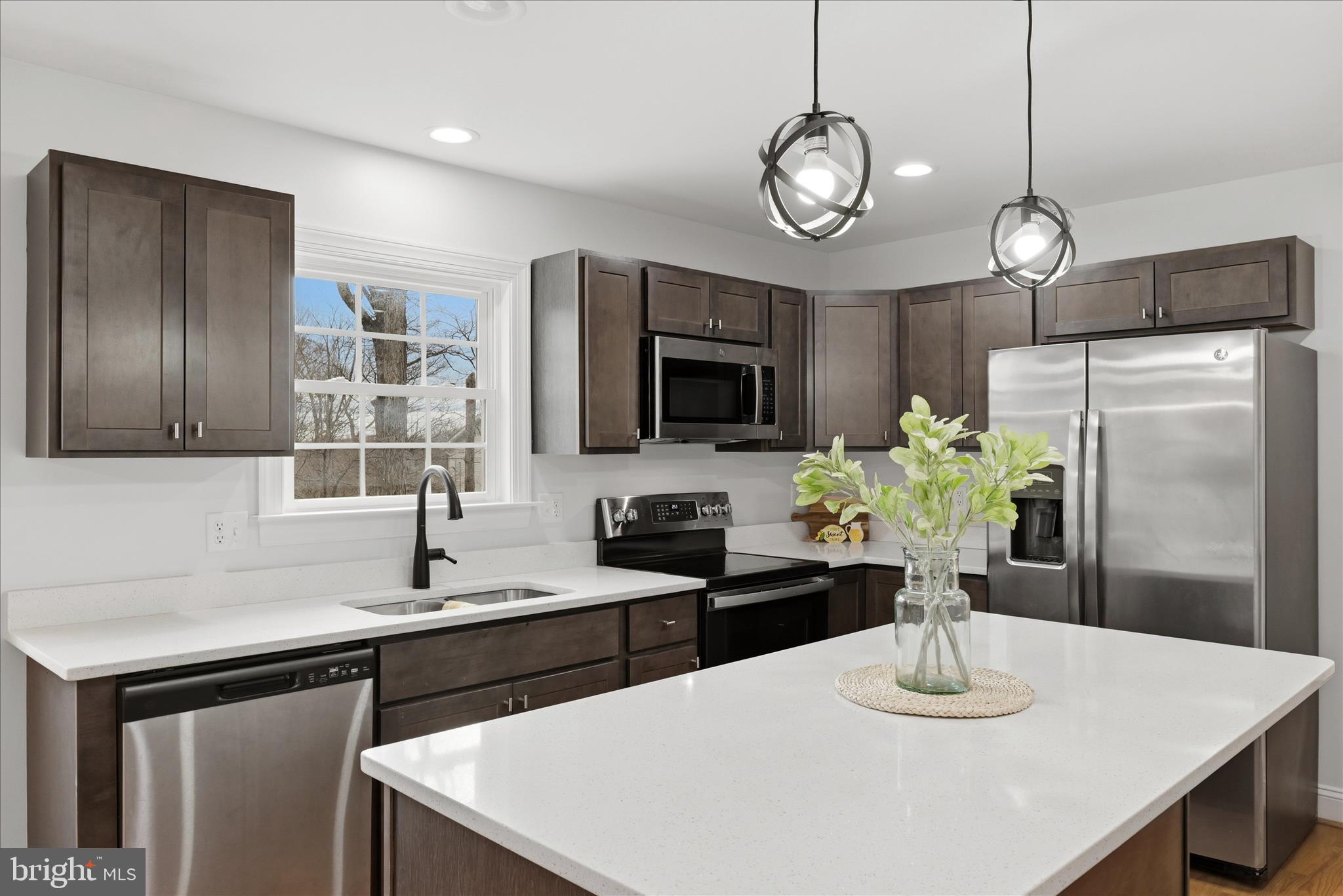 145 Graywolf Trail Winchester, VA 22602 - Photo 11 of 56 a kitchen with stainless steel appliances granite countertop a sink a stove top oven a refrigerator a dining table and chairs
