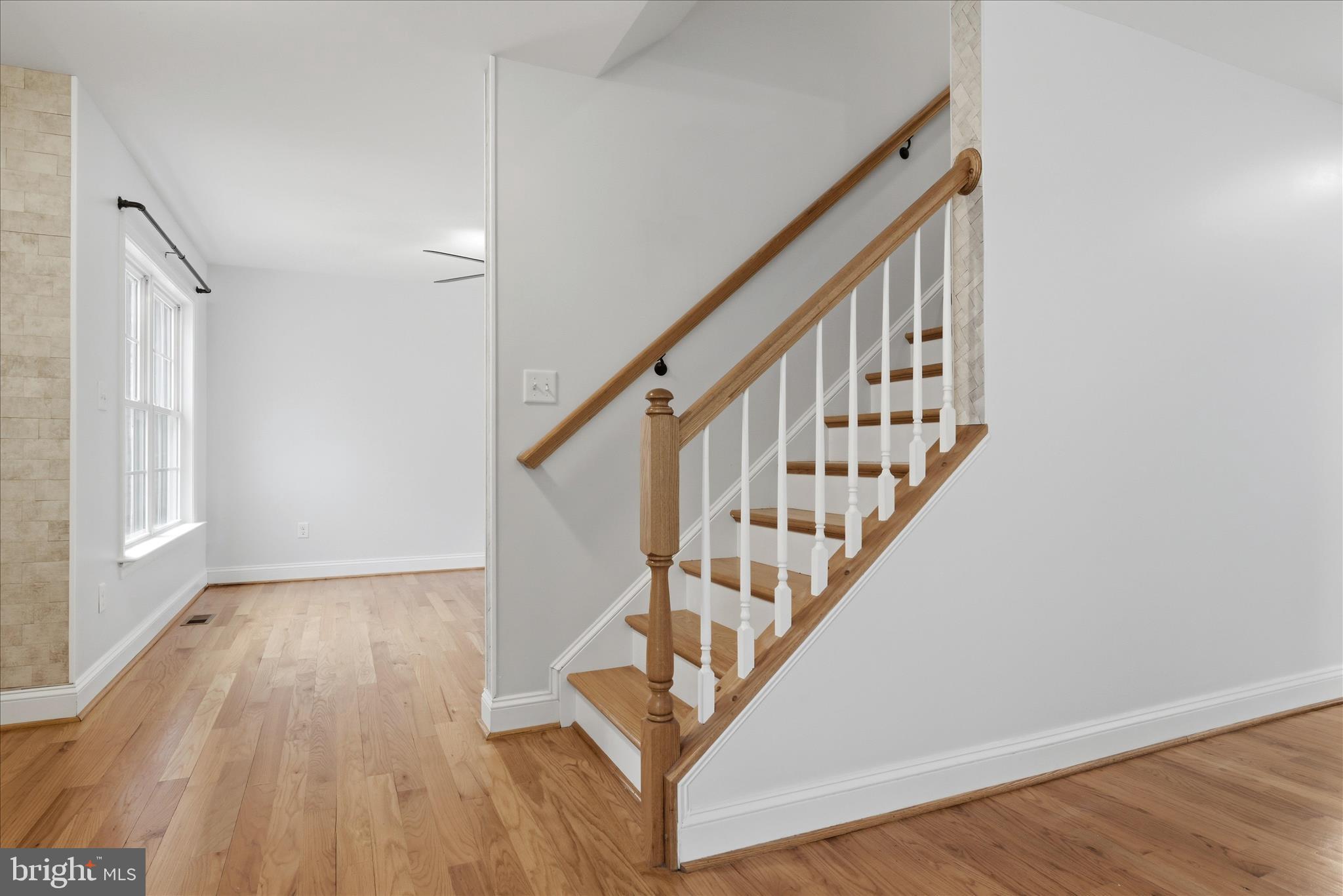 145 Graywolf Trail Winchester, VA 22602 - Photo 21 of 56 a view of staircase with wooden floor and white walls