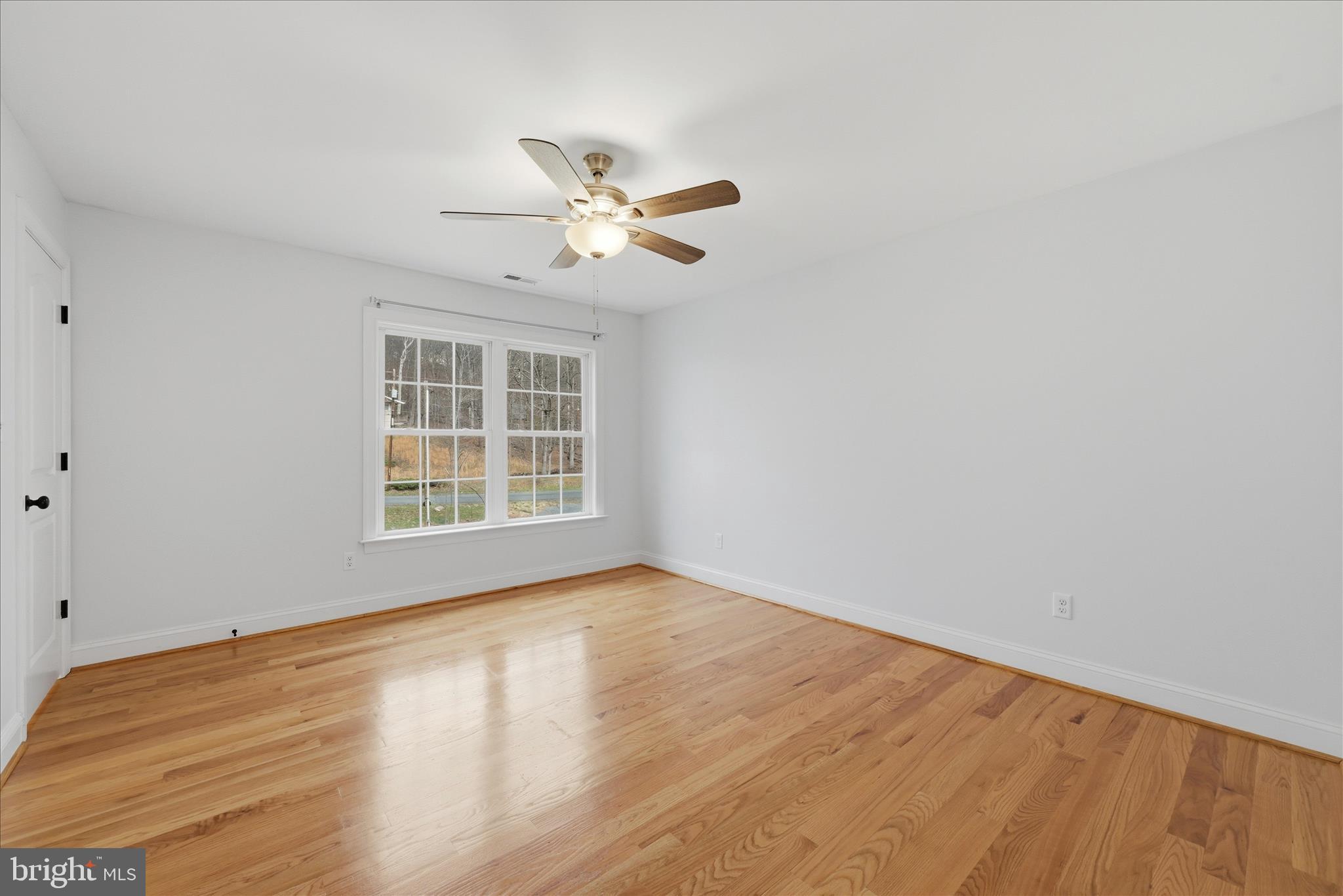 145 Graywolf Trail Winchester, VA 22602 - Photo 22 of 56 a view of empty room with wooden floor and fan