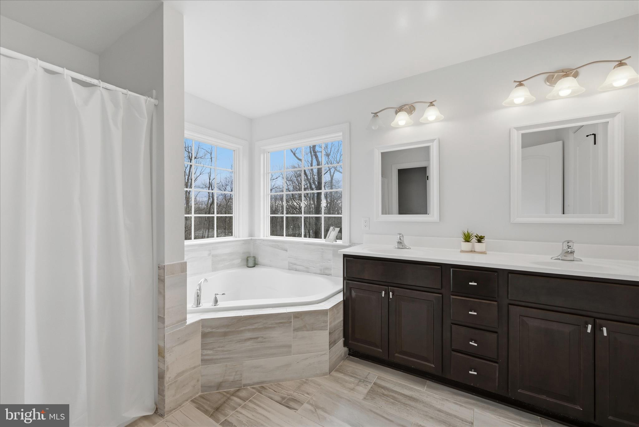 145 Graywolf Trail Winchester, VA 22602 - Photo 24 of 56 a bathroom with a tub sink double vanity granite and mirror