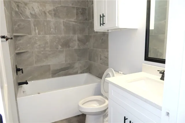 a bathroom with a sink a toilet and a bathtub