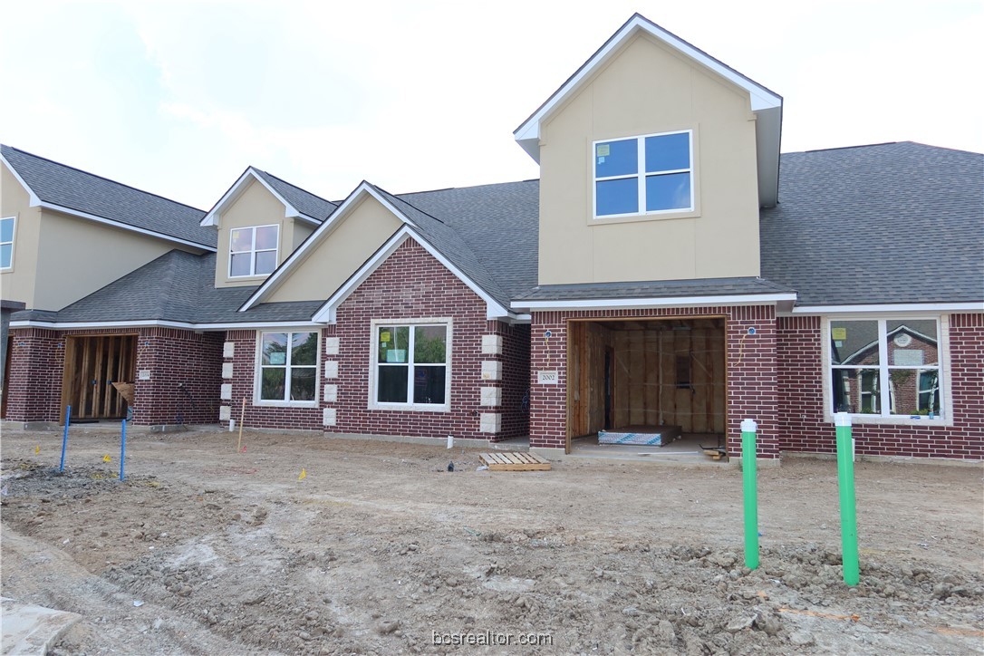 2006 Reagan Court Bryan, TX 77802 - Photo 3 of 17 a front view of a house with a yard and garage