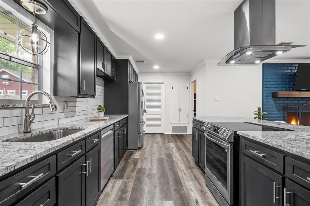 5704 Silver Lake Circle Waco, TX 76710 - Photo 12 of 36 a kitchen with granite countertop stainless steel appliances a sink stove top oven and cabinets