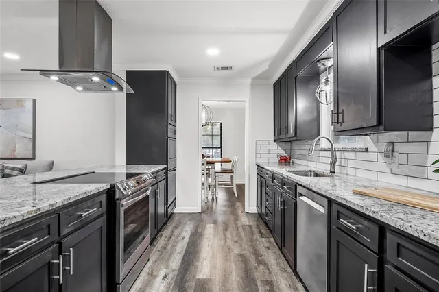 a kitchen with stainless steel appliances granite countertop a sink stove and refrigerator