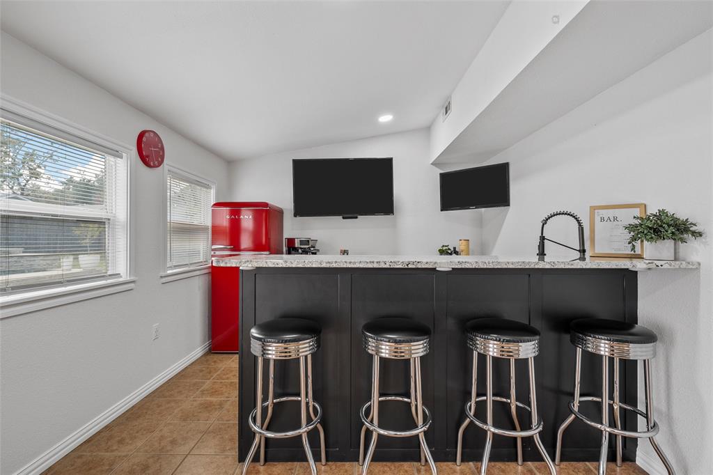 5704 Silver Lake Circle Waco, TX 76710 - Photo 16 of 36 a kitchen with a dining table chairs and white appliances