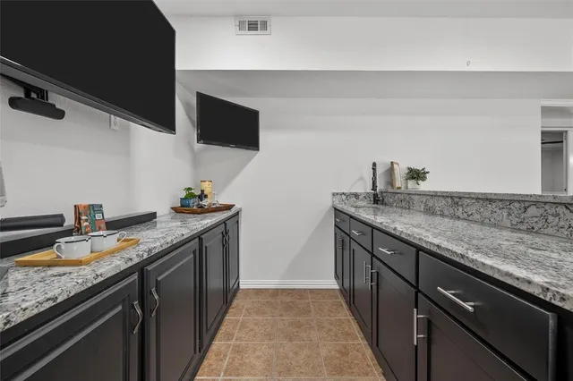 a kitchen with stainless steel appliances granite countertop a sink and a stove