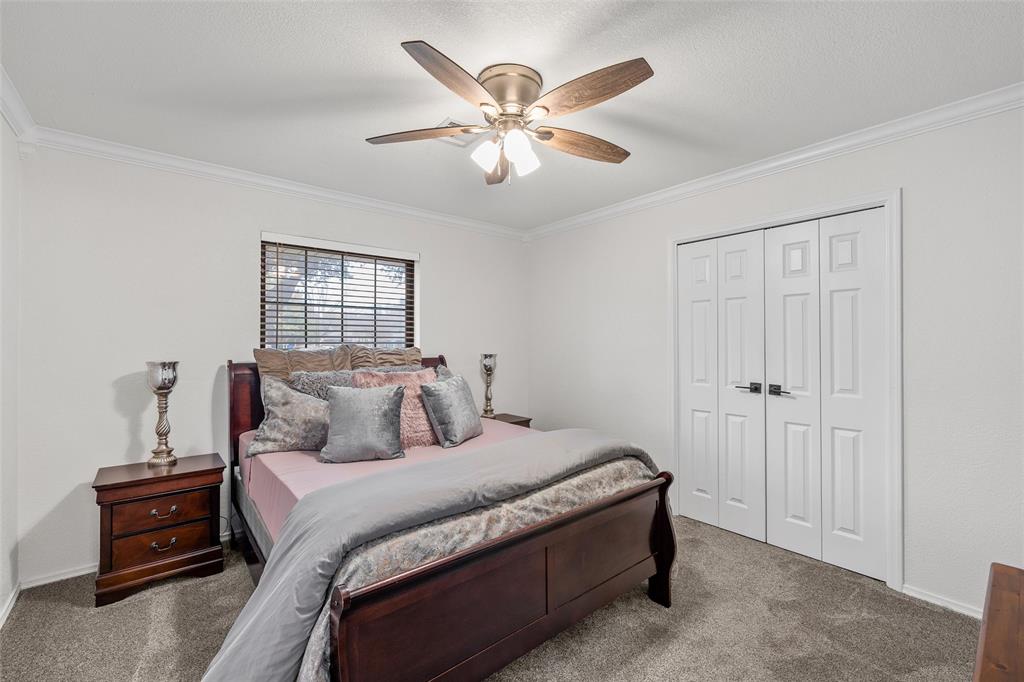 5704 Silver Lake Circle Waco, TX 76710 - Photo 27 of 36 a bedroom with a large bed and a chandelier