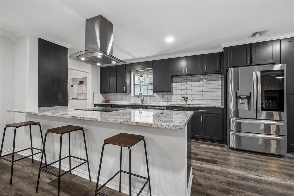 5704 Silver Lake Circle Waco, TX 76710 - Photo 4 of 36 a kitchen with stainless steel appliances granite countertop a kitchen island and chairs in it