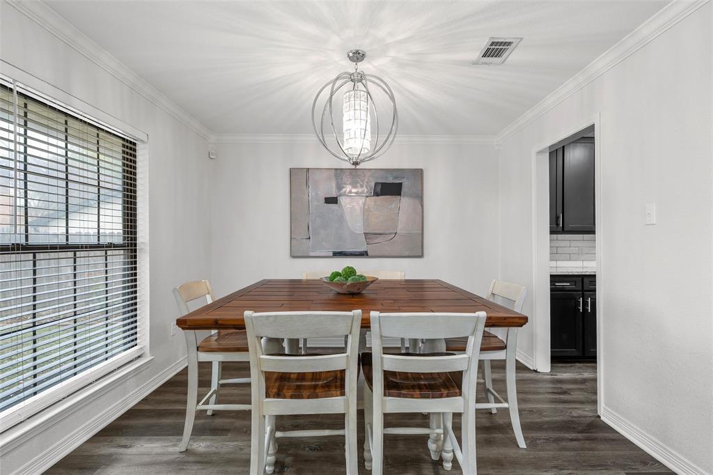 5704 Silver Lake Circle Waco, TX 76710 - Photo 9 of 36 a view of a dining room with furniture wooden floor and a chandelier