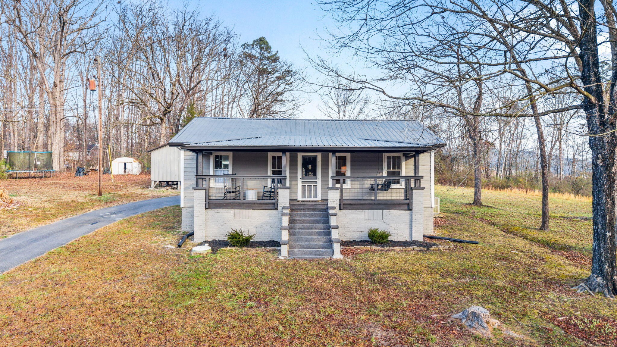 1210 Old Englewood Road Athens, TN 37303 - Photo 27 of 28 a front view of a house with a yard table and chairs