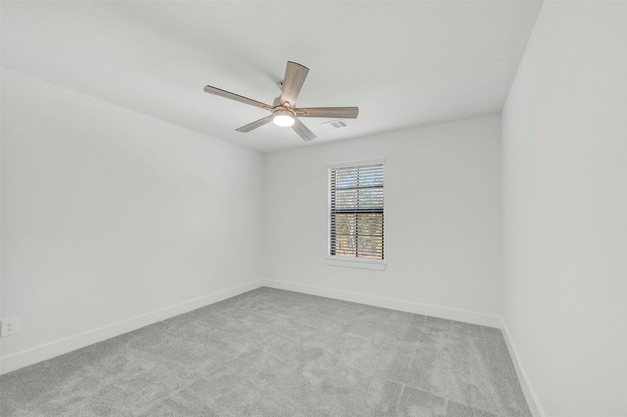 467 6th Street Magnolia, TX 77355 - Photo 15 of 50 an empty room with a window and ceiling fan