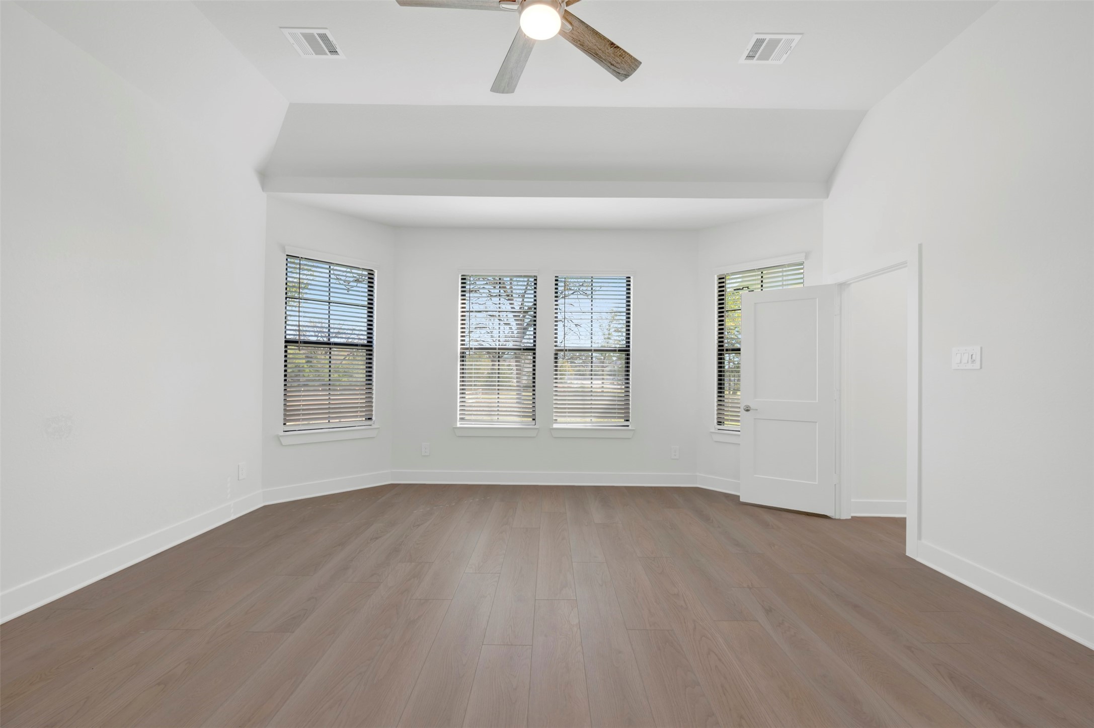 467 6th Street Magnolia, TX 77355 - Photo 36 of 50 an empty room with wooden floor chandelier fan and windows