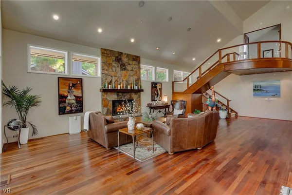 a living room with fireplace furniture and a wooden floor