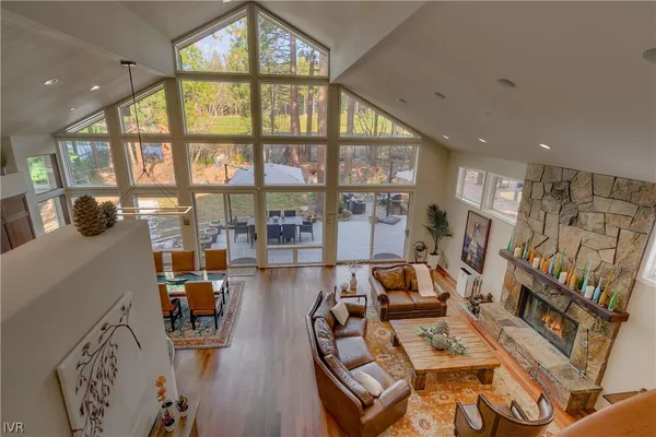 a kitchen with stainless steel appliances granite countertop a refrigerator a sink and a large window