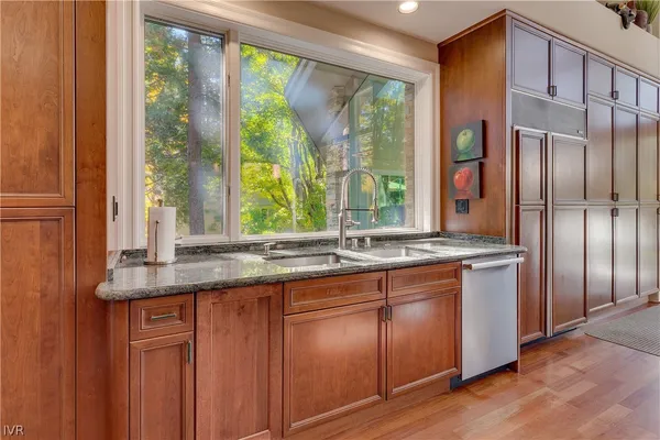 a kitchen with stainless steel appliances granite countertop a stove and a sink