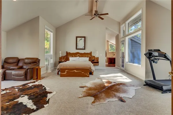 a bed room with a bed window and mirror