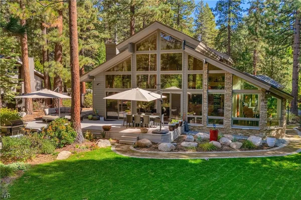 a view of a house with backyard porch and sitting area