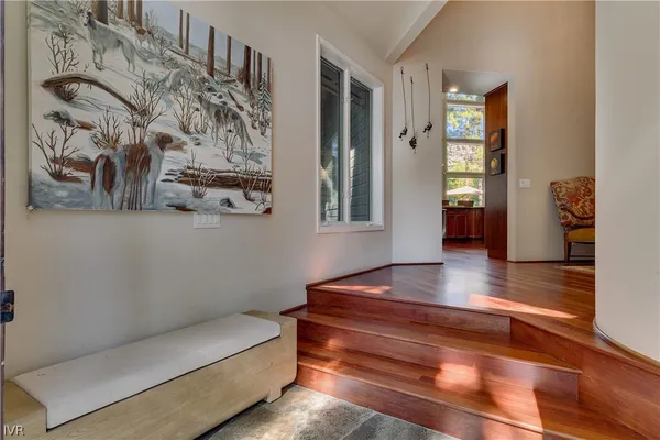 a living room with furniture a fireplace and a floor to ceiling window