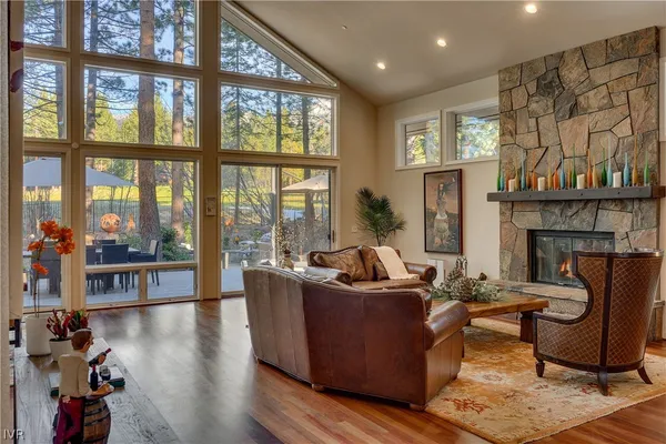 a living room with furniture and large windows
