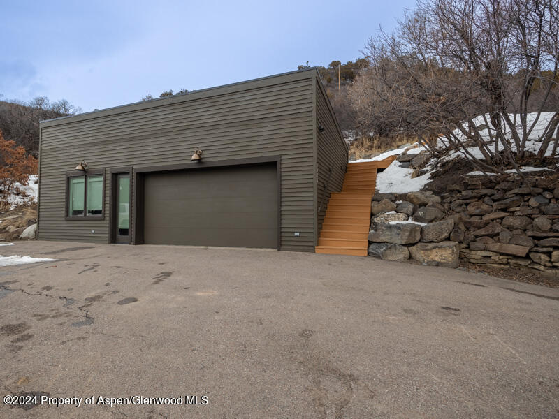 1711 Juniper Hill Road Aspen, CO 81611 - Photo 18 of 19 a front view of a house with a garage