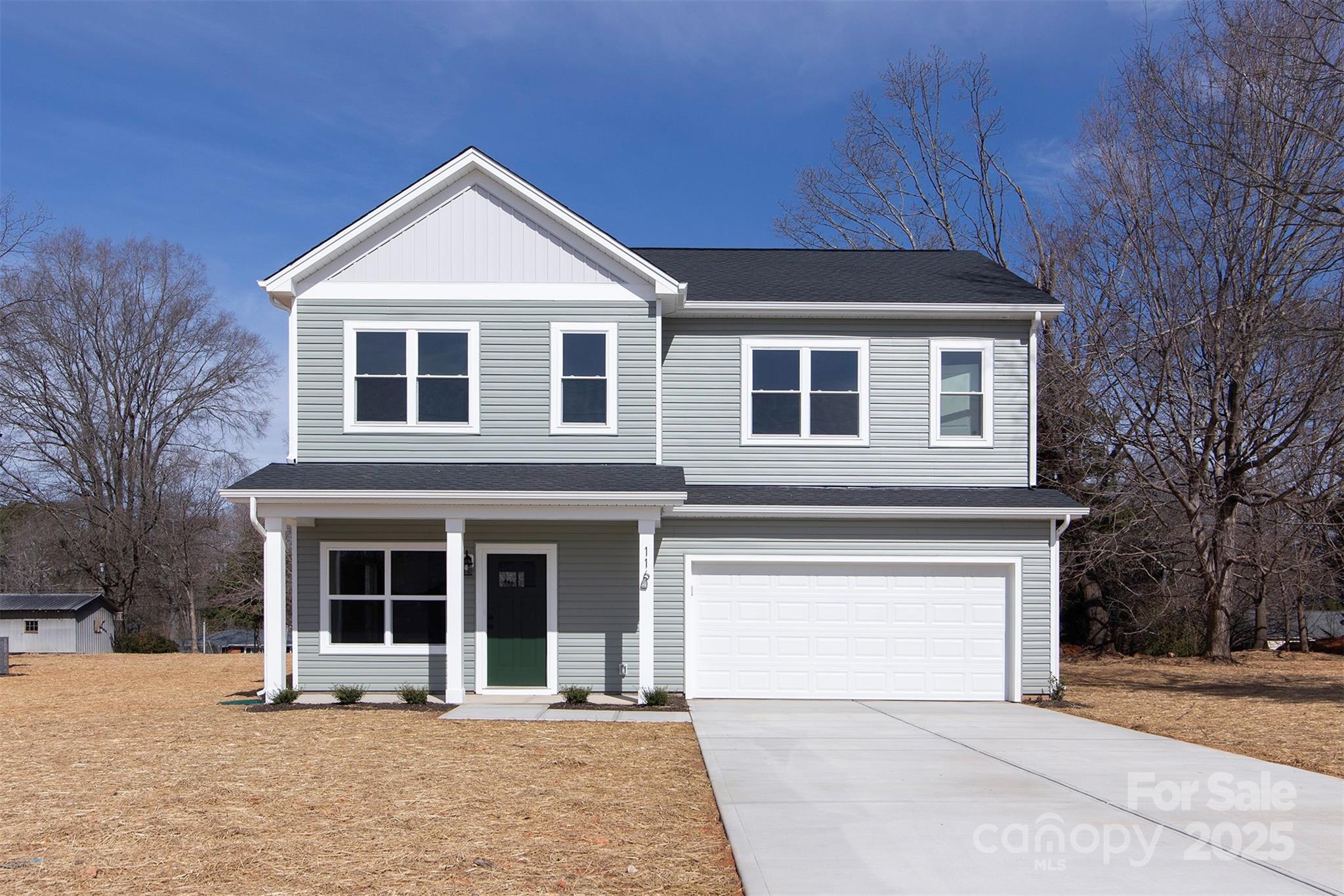 116 Durham Road Stanley, NC 28164 - Photo 1 of 25 a front view of a house with a yard and garage