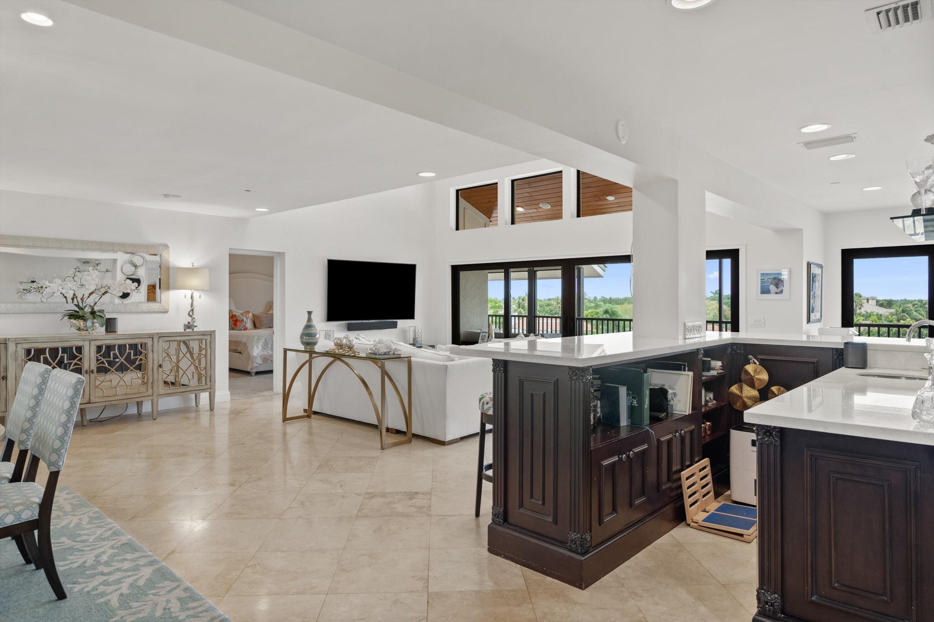 16910 Bay Street, Unit E 502 Jupiter, FL 33477 - Photo 12 of 43 a living room with furniture and a flat screen tv