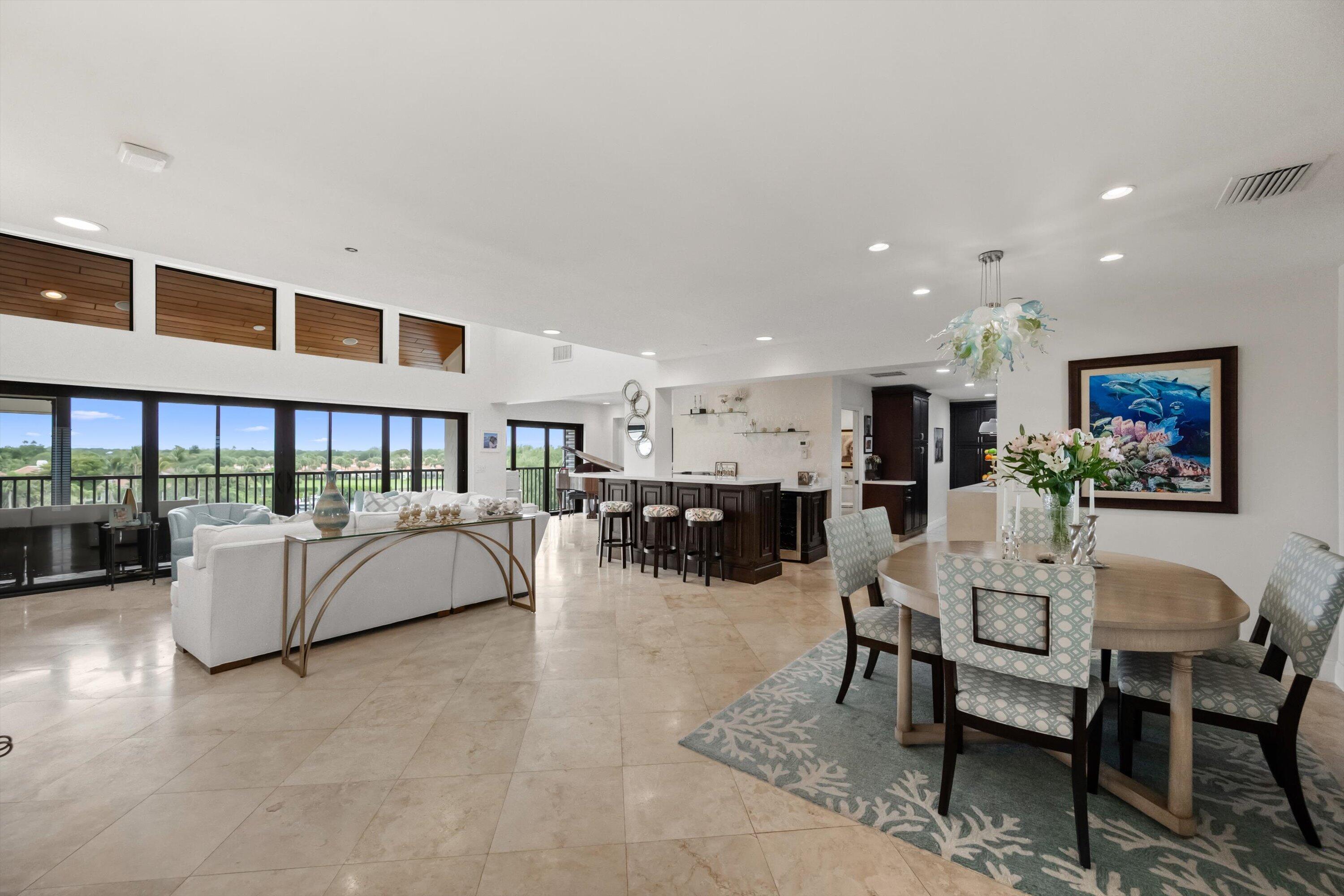 16910 Bay Street, Unit E 502 Jupiter, FL 33477 - Photo 2 of 43 a living room with furniture and a table